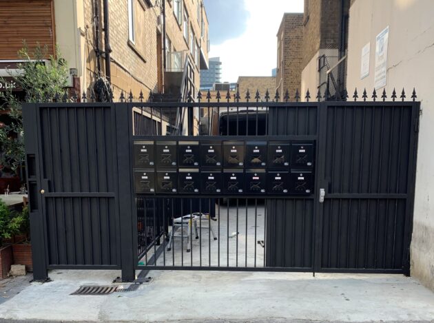 Custom black metal security gate installed at a residential property entrance in London.