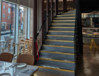 Custom steel staircase with metal railings installed inside a commercial property in London.