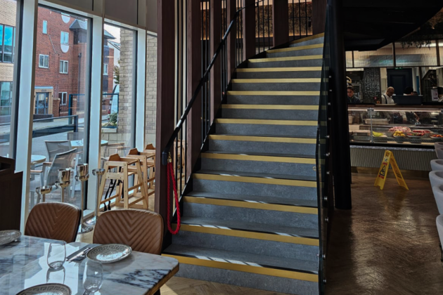 Custom steel staircase with metal railings installed inside a commercial property in London.