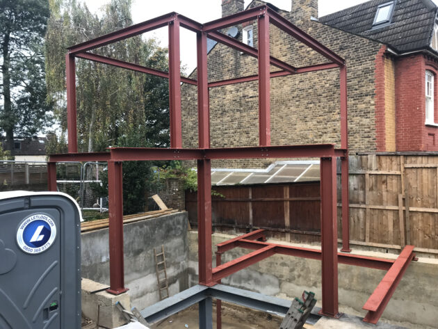 Commercial steel structure frame under construction with fabricated steel beams and columns.